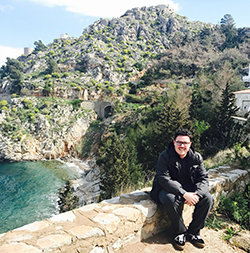 student sitting by mountain