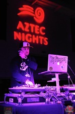 Aztec Nights logo behind a D.J.