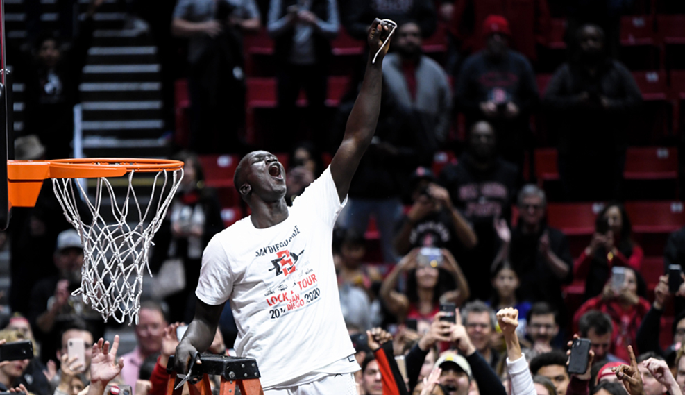 Aztecs Basketball player cutting the net