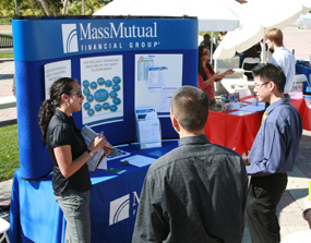 students visiting a booth at the career fair