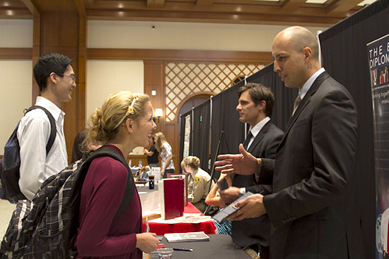 female student talking to guy at career fair