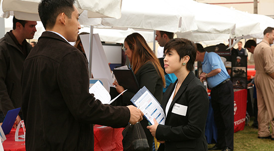 two people talking at career services fair