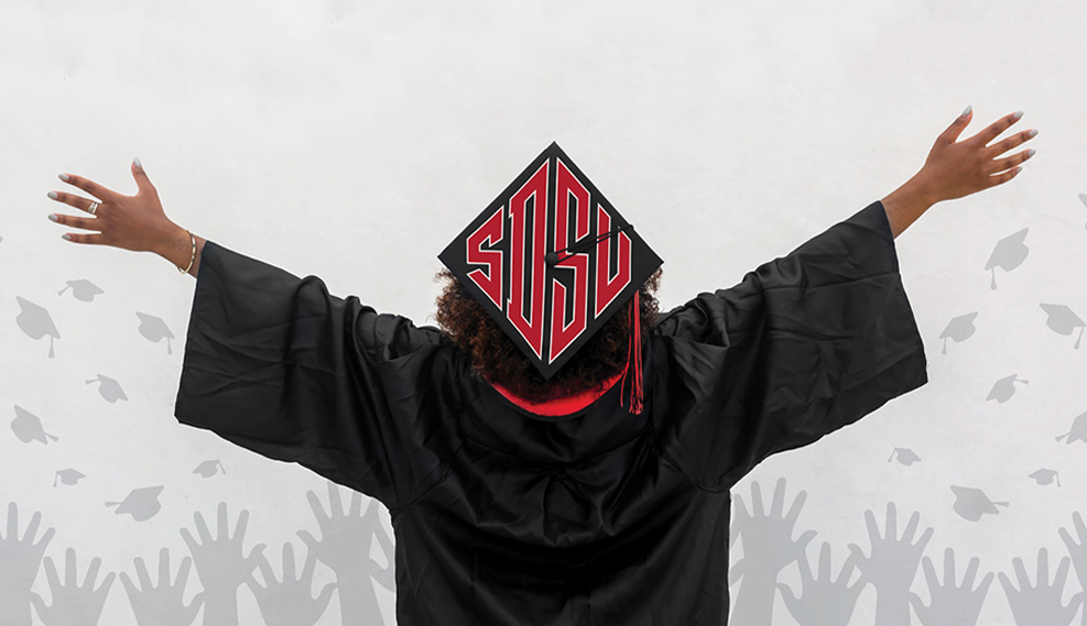 student in cap and gown with SDSU on top of the cap, background graphic of students throwing their caps in the air