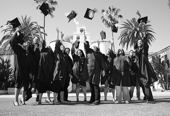 graduates tossing their caps