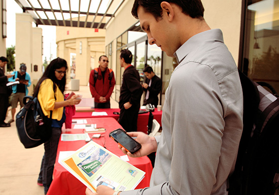 Student using cell phone to find jobs