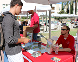 student at booth at study abroad fair