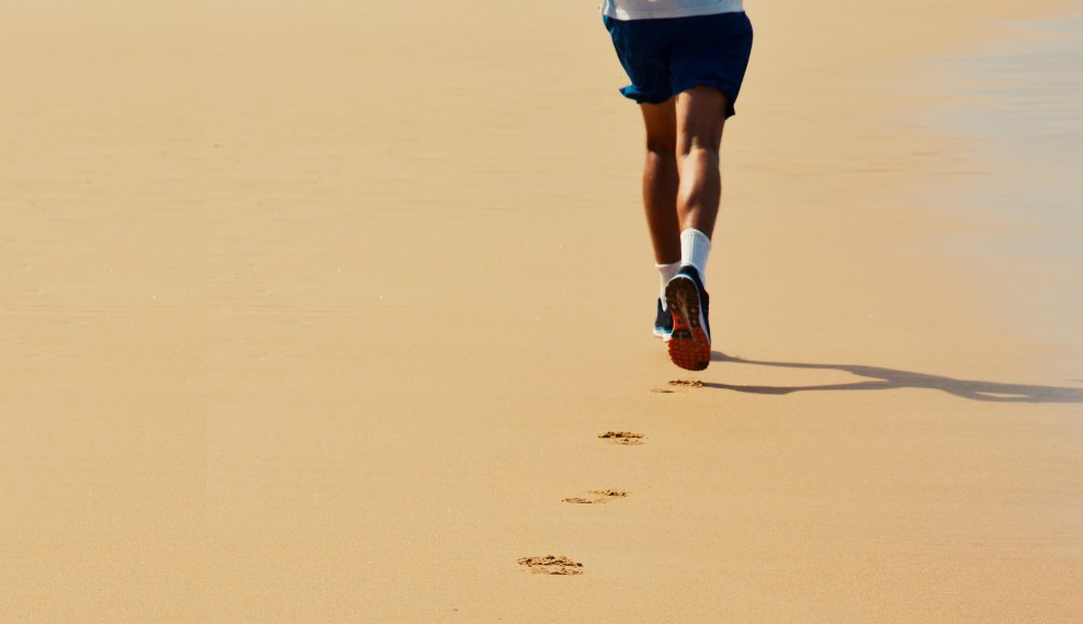 a runner running on the beach