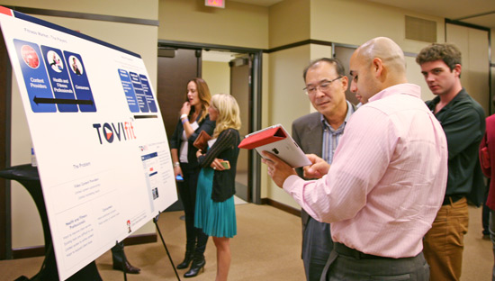 participants discuss a display poster